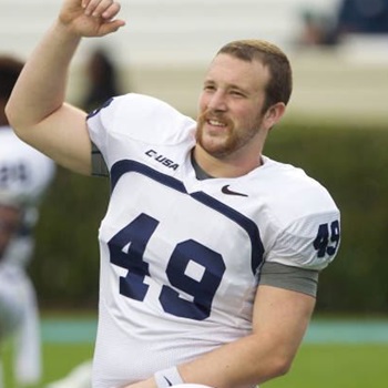 Rick Lovato Jr. stretches with his ODU team