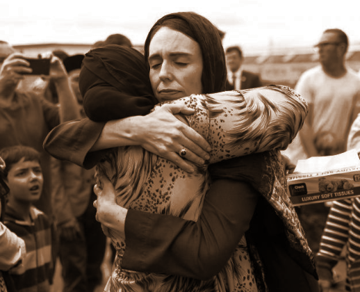 New Zealand Prime Minister Jacinda Ardern hugging comforting a woman after the Christchurch Mosque shootings
